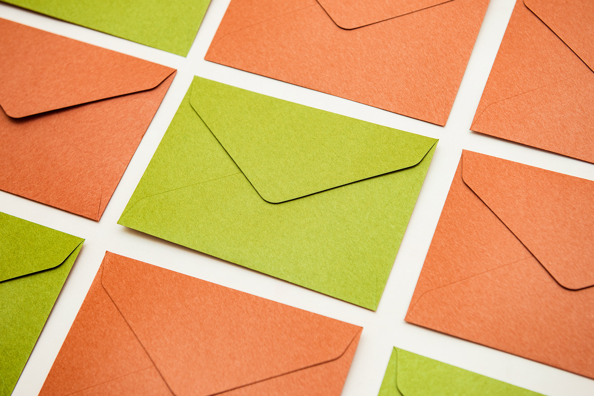 Colorful custom envelopes laid out in a grid, showcasing options for Envelope Printing in Calgary