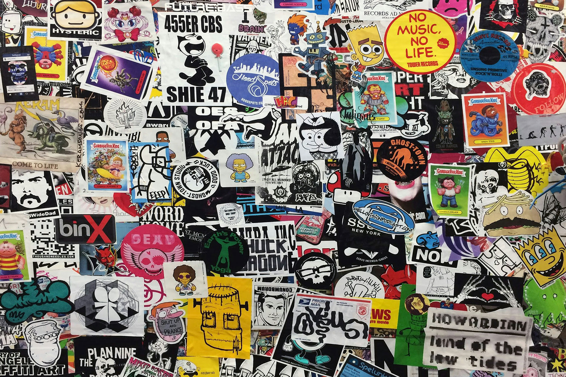 A wall covered in colorful, artistic stickers showcasing the creativity and variety possible with sticker printing in Calgary.